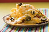 Tortilla chips with melted cheese and olives (Mexico)
