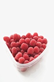 Raspberries in plastic container