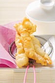 Deep-fried shrimps in batter on strainer (Asia)
