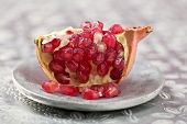 Wedge of pomegranate on plate