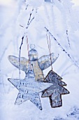 Stars and silver angel on snowy branch