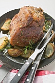 Veal loin steak with onions and rosemary in frying pan