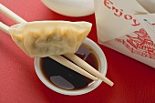 Dim sum with chopsticks and dip to take away (Asia)