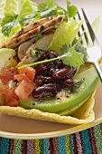 Chicken, vegetables & coriander leaves in taco shell (Mexico)