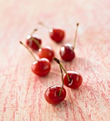 Several cherries on red patterned background