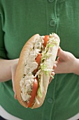 Woman holding chicken sandwich