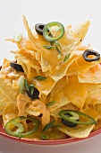 Nachos with cheese, olives and chilli rings