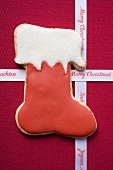 Boot biscuit and Christmas ribbon on red fabric