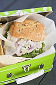 Chicken sandwich and crisps in lunch box (detail)