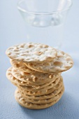 Crackers, stacked, in front of a glass