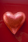 Heart-shaped chocolate in red foil