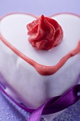 Pink heart-shaped cake with ribbon