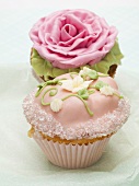 Two cupcakes with flower decorations