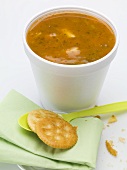 Tomato & vegetable soup in polystyrene cup, crackers