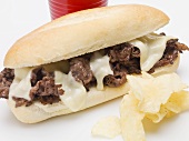 Shredded beef sandwich with melted cheese, crisps
