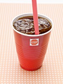 Cola with ice cubes in plastic cup