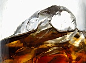 Glass of cola with ice cubes (close-up)