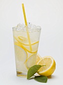 A glass of lemonade with crushed ice and straw
