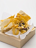 Tortilla chips with cheese, olives and onions to take away