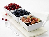 Fresh figs and berries in dishes
