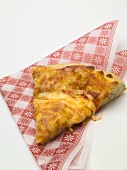 Slice of pizza Margherita (tomato & cheese pizza) on napkin