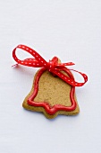 Bell-shaped Christmas biscuit with red bow