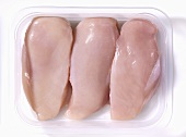 Fresh chicken breast fillets in plastic container