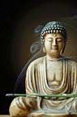 Buddha figure with incense sticks