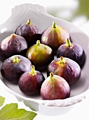 Several figs in white bowl