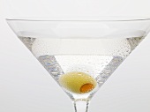Martini with green olive (close-up)