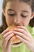 Little girl eating hamburger