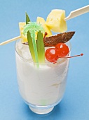 Piña Colada with pineapple skewer and cocktail cherries