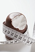 Chocolate-coated marshmallow treat with tape measure