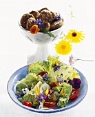 Mixed salad with edible flowers, burgers