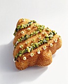 Cake in the shape of a Christmas tree with pistachios