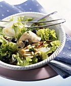 Green salad with turkey breast, olives and pine nuts
