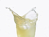 Lemonade splashing out of a glass