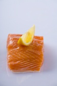 Salmon fillet with lemon wedge