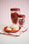 Cream-filled sandwich cookies, two jars of sweets