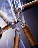 Five Lit Smoking Cigars