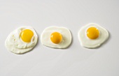 Three Fried Eggs on White