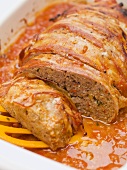 Bacon-wrapped meatloaf in tomato sauce