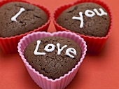 Heart-shaped chocolate muffins with sugar writing
