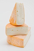 Three pieces of washed-rind cheese
