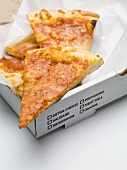 Several slices of pizza in a pizza box