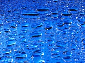 Drops of water on sheet of blue glass