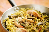 Pan-cooked pasta dish with prawns and artichokes