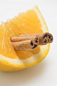 Orange wedge with cinnamon sticks