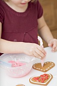 Little girl decorating biscuits