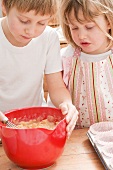 Boy and girl making muffin mixture